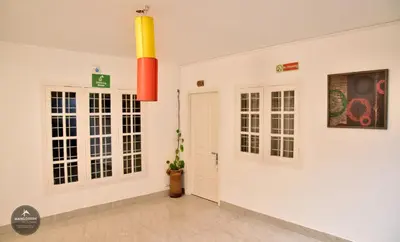 a room with white walls and a door with windows at mangosteen holidays in Vythiri