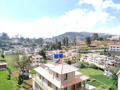 an aerial view of a city with houses at A Ooty Honey Huts in Ooty