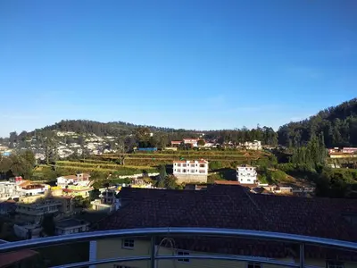 a view of a city with houses and a mountain at A Ooty Honey Huts in Ooty
