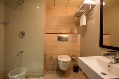 a bathroom with a toilet and a sink at THE CASTELLO RESIDENCY in Coimbatore