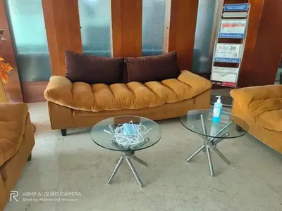 a living room with a couch and two tables at THE CASTELLO RESIDENCY in Coimbatore