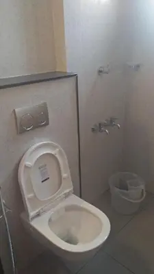 a bathroom with a toilet with the seat up at LEMON RESIDENCY By Chungath in Trichūr