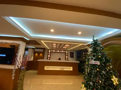 a christmas tree in the lobby of a hotel at Utsavam Hotel Apartments in Guruvāyūr