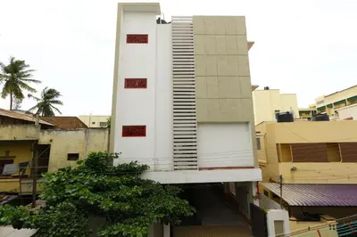 a tall white building on top of a city at Sri Kamadhenu Residency in Coimbatore