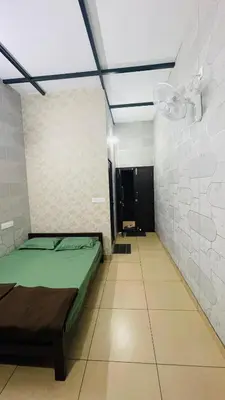 a room with a bed and a ceiling fan at Caffeine Villa in Kaniyāmbetta