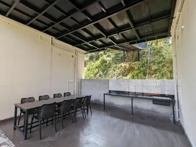 a room with a table and chairs and a window at Caffeine Villa in Kaniyāmbetta
