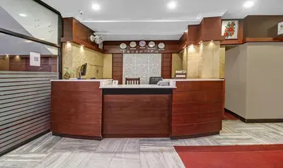 a lobby with a counter in a building at Treebo Darwesh Residency - 500m from Railway Station in Kozhikode