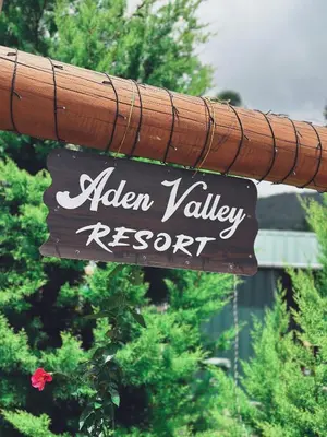 a sign for aller valley resort on a pole at Aden Valley in Kanthalloor