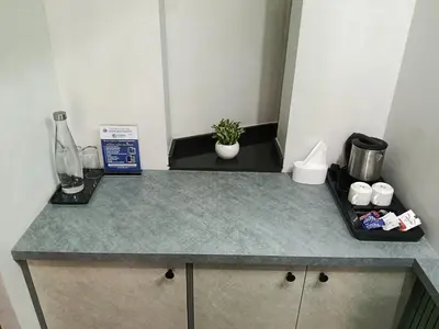 a kitchen with a counter top with a coffee maker at Green Planet Resort in Mattanūr