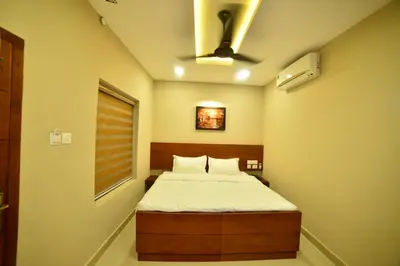 a bedroom with a bed and a window at Hotel Priya in Kottakkal