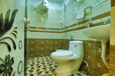 a bathroom with a toilet and a sink at karibu Residency in Malappuram