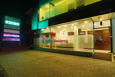a store front of a building at night at karibu Residency in Malappuram