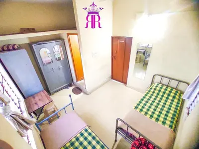 a hospital room with two beds and a waiting room with a ticket machine at RR Paying Guest in Mysore