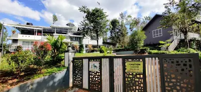 a fence in front of a house at Villa Tesori Homestay Wayanad in Meppādi