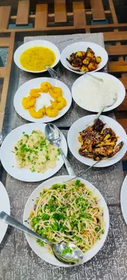 a table full of plates of food on a table at Villa Tesori Homestay Wayanad in Meppādi