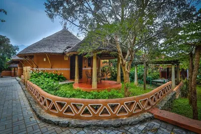 a house with a garden in front of it at My Village - Eco Rural Resort in Coimbatore