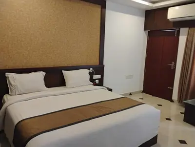 a bedroom with a large bed in a room at Hotel Emperor in Kannur