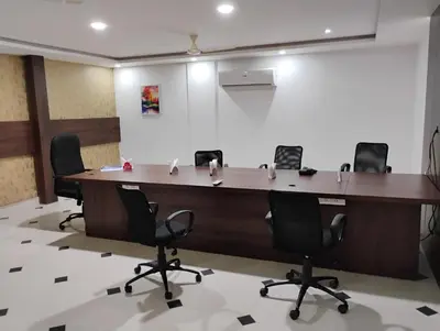 a conference room with a large table and chairs at Hotel Emperor in Kannur