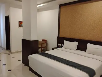 a bedroom with a large bed in a room at Hotel Emperor in Kannur