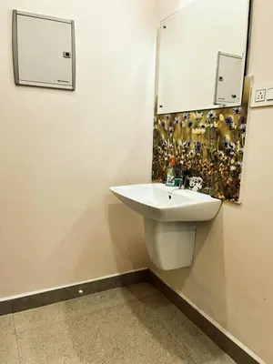 a bathroom with a white sink and a mirror at Thrissur Villas Home Stay in Trichūr