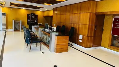 an office with a desk with chairs and a computer at KPM Regency in Palakkad