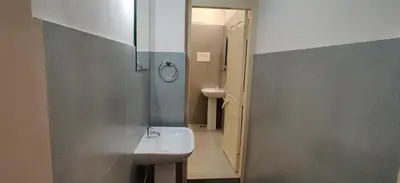 a bathroom with a sink and a mirror at Garden House in Mysore