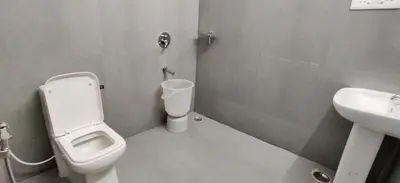 a bathroom with a toilet and a sink at Garden House in Mysore