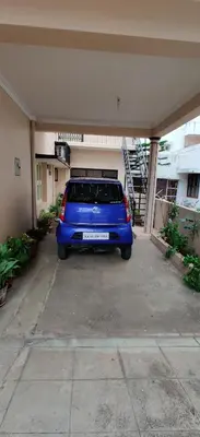 a blue car is parked in a garage at Garden House in Mysore