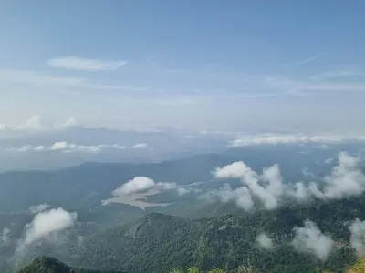 a view of a mountain range with clouds in the sky at Camellia Heights 1&2 in Coonoor