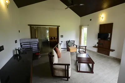 a living room with a couch and a table at vihangama Home Stay in Chāmundi