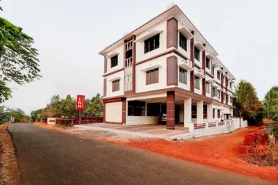 a large white building on the side of a road at SPOT ON Rohini Inn Kadampuzha in Malappuram
