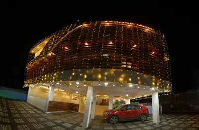 a car parked in front of a building at night at Gateway Airport Hotel in Kannur