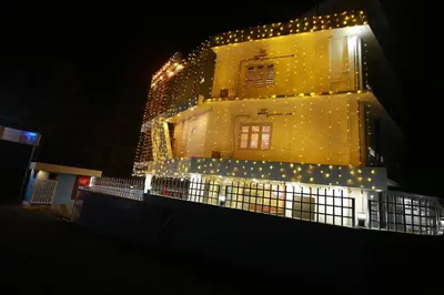 a large building with lights on it at night at Gateway Airport Hotel in Kannur