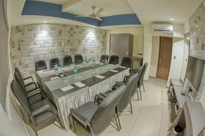 a conference room with a long table and chairs at AS AIRPORT Inn in Cochin