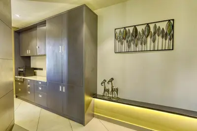 a kitchen with stainless steel cabinets and a counter at AS AIRPORT Inn in Cochin