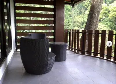 two wicker trash cans sitting on a porch at Serene Woods in Madikeri