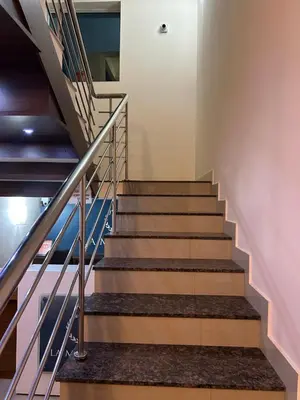 a staircase in a building with blue and white walls at La Mer Inn in Kozhikode