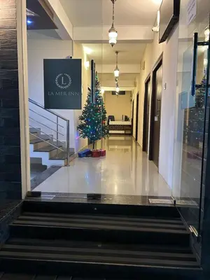 a christmas tree in the middle of a hallway at La Mer Inn in Kozhikode