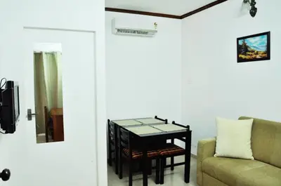 a living room with a table and a couch at Sayoojyam Residency in Palakkad