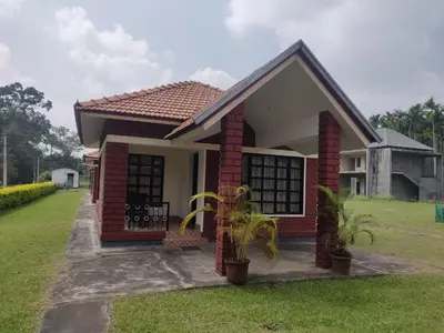 a small house with a red brick at Dubare Inn Coorg in Madikeri