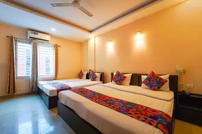 a hotel room with two beds in a room at Zion Plaza in Nedumbassery