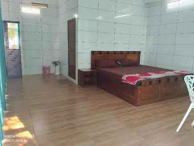 a bedroom with a bed and a wooden floor at CHILLAX Resorts Palakkayam THATTU in Paithalmala