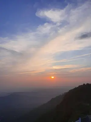 a view of the sun setting over a mountain at CHILLAX Resorts Palakkayam THATTU in Paithalmala