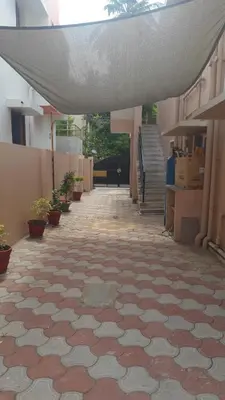 an empty hallway of a building with a tile floor at Happy Home in Coimbatore