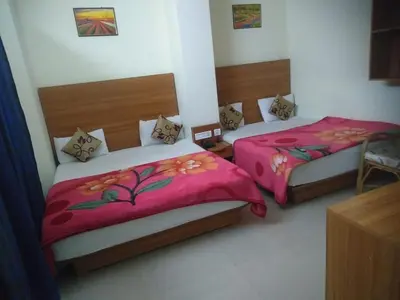 two beds in a room at Red Star Holidays in Munnar