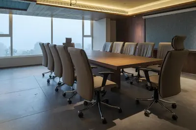a conference room with a wooden table and chairs at GRANDE IRIS in Sultan Bathery