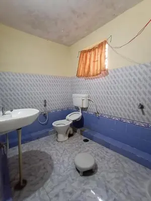 a bathroom with a toilet and a sink at KABINI FARM STAY in Antarasante