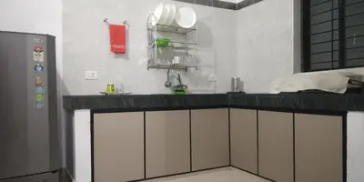 a kitchen with a counter top and a sink at Pearl Inn in Kottakkal