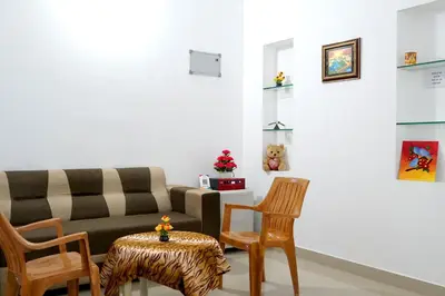 a living room with a couch and two chairs at Pearl Inn in Kottakkal