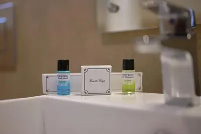 three bottles of essential oils sitting on a bathroom counter at Tea Garden Riverside in Munnar